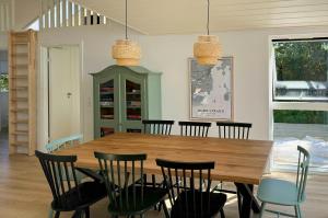 a dining room with a wooden table and chairs at Modern House In Second Row At Rude Strand in Odder