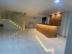 a large room with a staircase and a brick wall at Oasis Hotel Jojutla in Vallespin