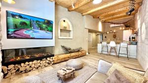 a living room with a fireplace and a large screen tv at Bankers 1880 The Turkish Quarter hotel in Haifa