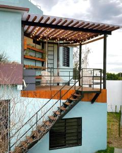 a deck with a pergola on the side of a house at Casa Terraza Oaxaca in San Sebastián Etla