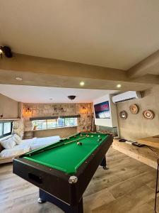a bedroom with a pool table in a room at Bankers 1880 The Turkish Quarter hotel in Haifa