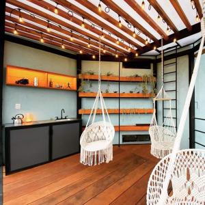 a room with three swinging chairs and a kitchen at Casa Terraza Oaxaca in San Sebastián Etla