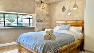 a bedroom with a bed with towels on it at Bankers 1880 The Turkish Quarter hotel in Haifa