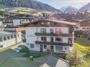 a building in a town with mountains in the background at Hohe Tauern-Großvenediger in Mittersill