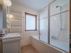 a bathroom with a tub and a sink and a shower at Hohe Tauern-Großvenediger in Mittersill +21 photos