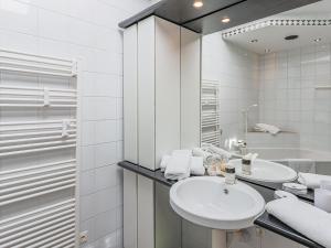 a white bathroom with a sink and a shower at Itterblick in Itter +34 photos