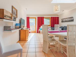 a kitchen and dining room with a table and chairs at Itterblick in Itter