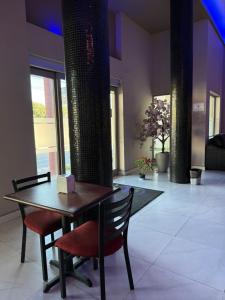 a dining room with a table and two chairs at Hotel Plaza Arteaga in Monterrey