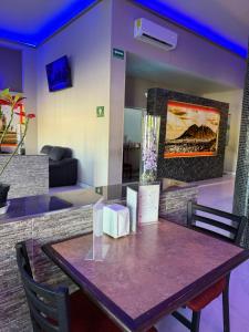 a table in a living room with a couch at Hotel Plaza Arteaga in Monterrey