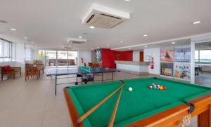a room with a pool table and ping pong balls at Flat Premium Manaus no Adrianópolis in Manaus