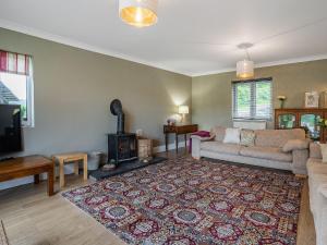 a living room with a couch and a fireplace at Taliaris Isaf in Llandeilo