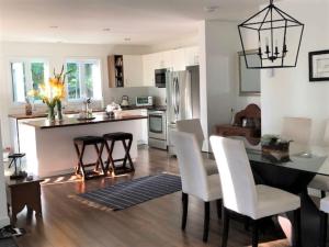 a kitchen and dining room with a table and chairs at Rooms in peaceful nature settings in Sutton
