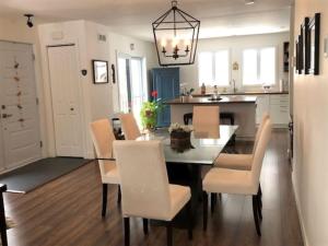 a kitchen and dining room with a table and chairs at Rooms in peaceful nature settings in Sutton +13 photos
