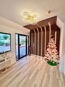 a christmas tree in the middle of a living room at Island Suites Hobby Airport in Houston
