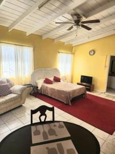 a living room with a bed and a couch at Amber Lily Studio in Brumaire