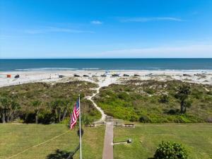 a view of a beach with an american flag at Spanish Trace 235 in St. Augustine
