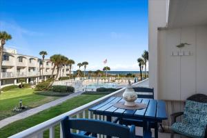 a balcony with a table and chairs and a view of the ocean at Spanish Trace 235 in St. Augustine +28 photos