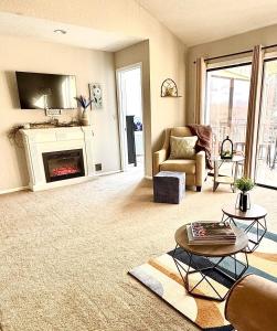 a living room with a couch and a fireplace at Lakefront Condo Private Deck 3 Pools in Osage Beach