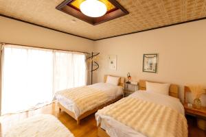 a bedroom with two beds and a window at inn 1st in Yakage