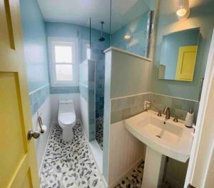 a bathroom with a sink and a toilet at Nautical Endeavors Beach House Steps from Surf in Rodanthe +20 photos