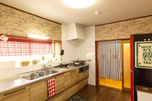 a kitchen with a sink and a counter top at inn 1st in Yakage