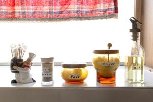 a shelf with bottles of essential oils on a window sill at inn 1st in Yakage +20 photos