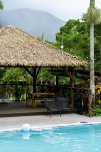 a pavilion with a table and chairs and a pool at Tasman Holiday Parks - Cairns Cool Waters in Cairns