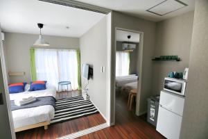 a bedroom with a bed and a door leading into a room at QU302 EPrivate 2BR Home with Living Room and Kitchen, Separate Bath and Toilet, Sleeps 4 in Tokyo