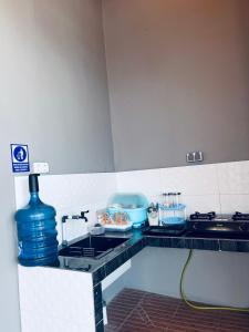 a kitchen counter with a sink and a stove at Lora House in Sukoharjo