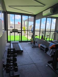 a gym with several treadmills and machines in a room at Lindo Studio com rooftop e piscina in Cabedelo