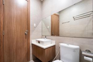 a bathroom with a toilet and a sink and a mirror at Jade House Tran Cao Van in Ho Chi Minh City +49 photos