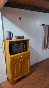 a microwave sitting on top of a cabinet in a room at La Reina in Eldorado