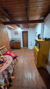 a living room with a table and a wooden floor at La Reina in Eldorado