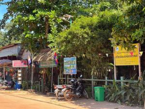 a motorcycle parked on the side of a street at កុយ ឡាយ-Koy Lay in Chi Phat
