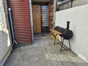a grill sitting outside of a garage with a door at Departamentos H&G in Punta Arenas