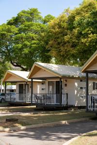 a white house with a porch and a car at BIG4 Tasman Holiday Parks - Rowes Bay in Townsville