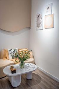 a living room with a couch and a table at Aimee House Vũ Miên in Hanoi