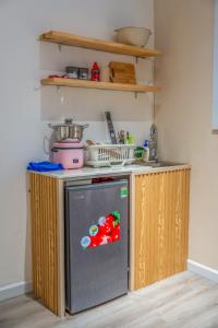 a kitchen with a small refrigerator and a counter at Aimee House Vũ Miên in Hanoi