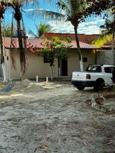 a white truck parked in front of a house at Casa Completa Proximo ao Frances in Marechal Deodoro