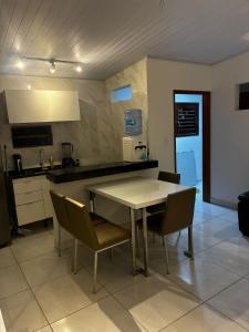 a kitchen with a table and chairs in a room at Casa Completa Proximo ao Frances in Marechal Deodoro