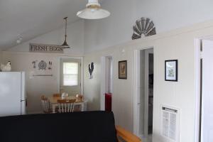 a kitchen and dining room with a table and a refrigerator at Dockside Lake Resort in Monticello