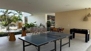 a room with two ping pong tables and a pool table at Flat Inteiro no Makia Beach Experience in Porto De Galinhas