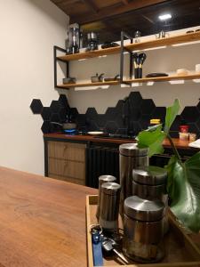 a kitchen with a wooden table with a counter top at Shangri-lá Chalés in Gonçalves