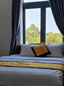 a bed with a window with a no entry pillow at Nhi Quỳnh La Gi Hotel in Lagi