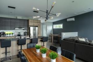 a kitchen and living room with a couch and a table at Roi de la Montagne-295 in Saint-Jean-de-Matha