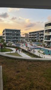 a view of a resort with a pool and buildings at Flat Inteiro no Makia Beach Experience in Porto De Galinhas