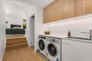 a kitchen with a washing machine and a sink at Blenheim Breeze by Experience Jervis Bay in Vincentia
