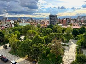 an aerial view of a city with trees and buildings at Urban Escape Sky View in Cochabamba