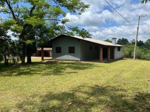 a house with a large yard in front of it at Recanto do sossego in Gravataí