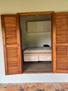 a small bedroom with a bed in a room at Recanto do sossego in Gravataí +8 photos
